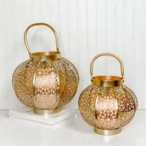 Decorative metal hurricane lantern in golden color in round shape for decoration .