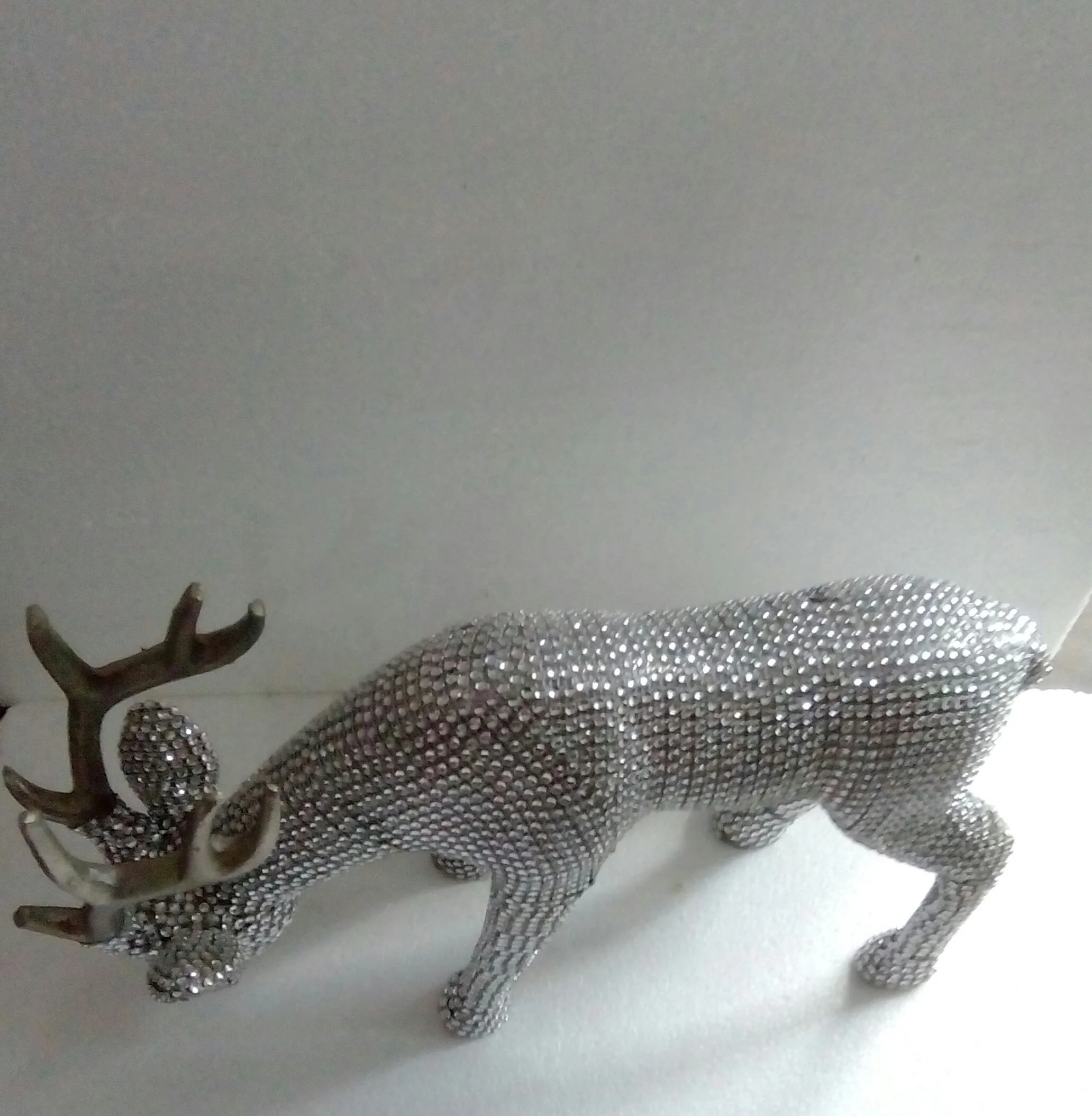 Decorative metal Deer in aluminum with golden horns and beads .