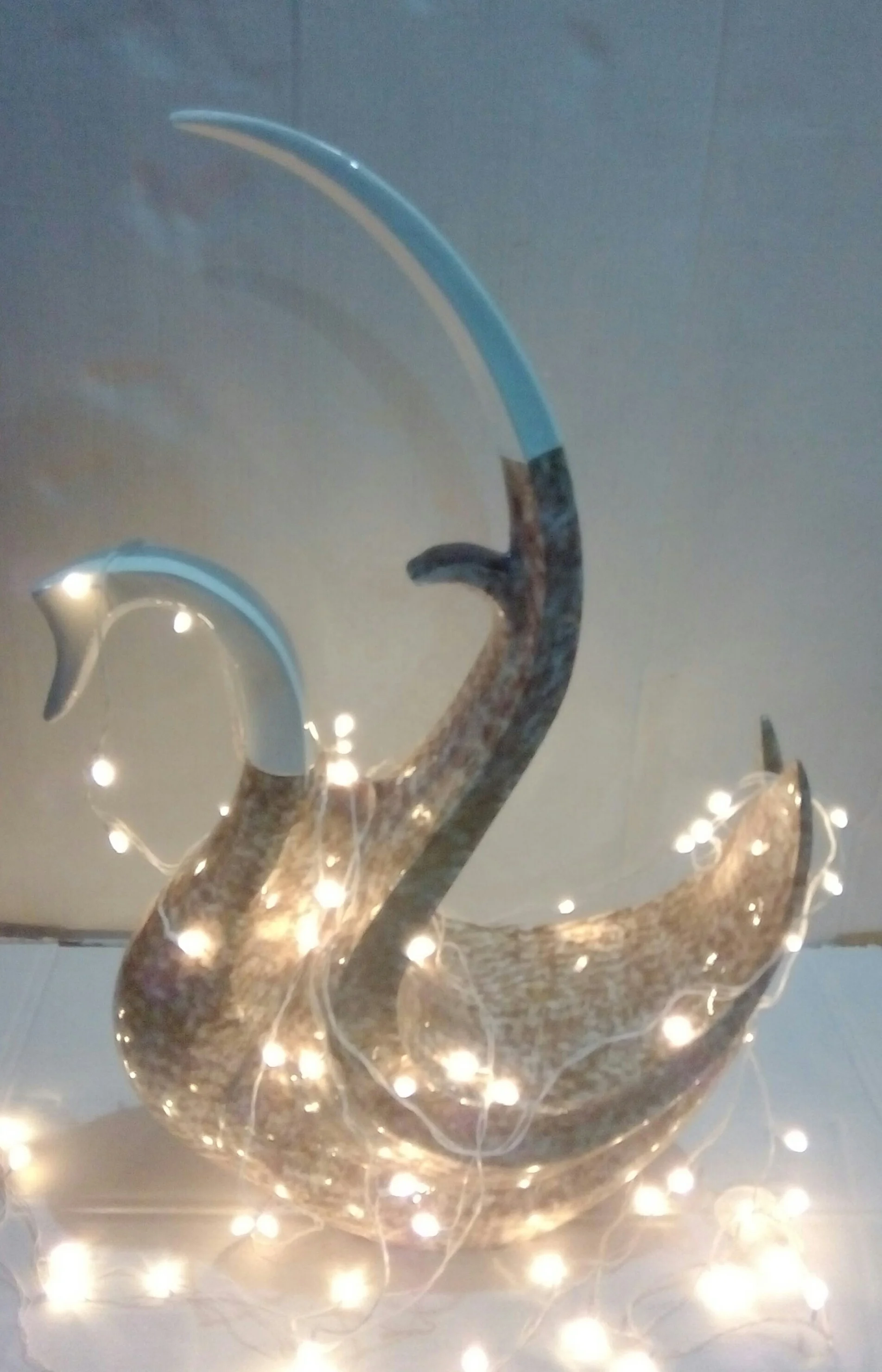Metal decorative swan in white and golden color .