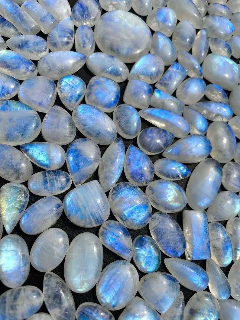 Natural Rainbow Moonstone Oval Calibrated Gemstone Cabochons Flat Back 5X3 mm To 30X20 mm Sizes Blue Moonstone at Bulk Prices