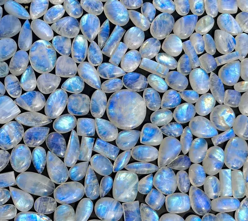 Natural Rainbow Moonstone Oval Calibrated Gemstone Cabochons Flat Back 5X3 mm To 30X20 mm Sizes Blue Moonstone at Bulk Prices
