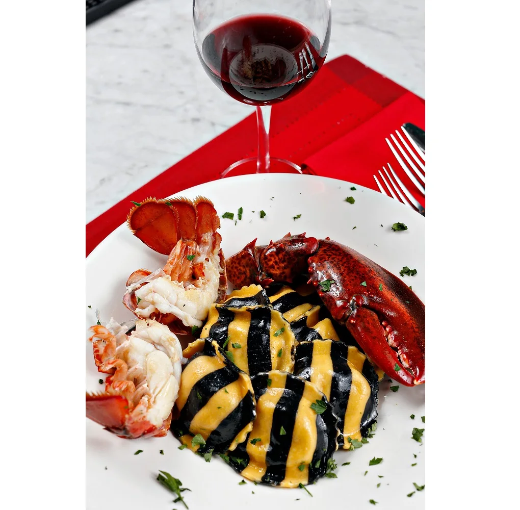 
Striped North Atlantic Lobster Ravioli Egg & Squid Ink Dough Round Knuckle Claw Fresh herbs & butter 