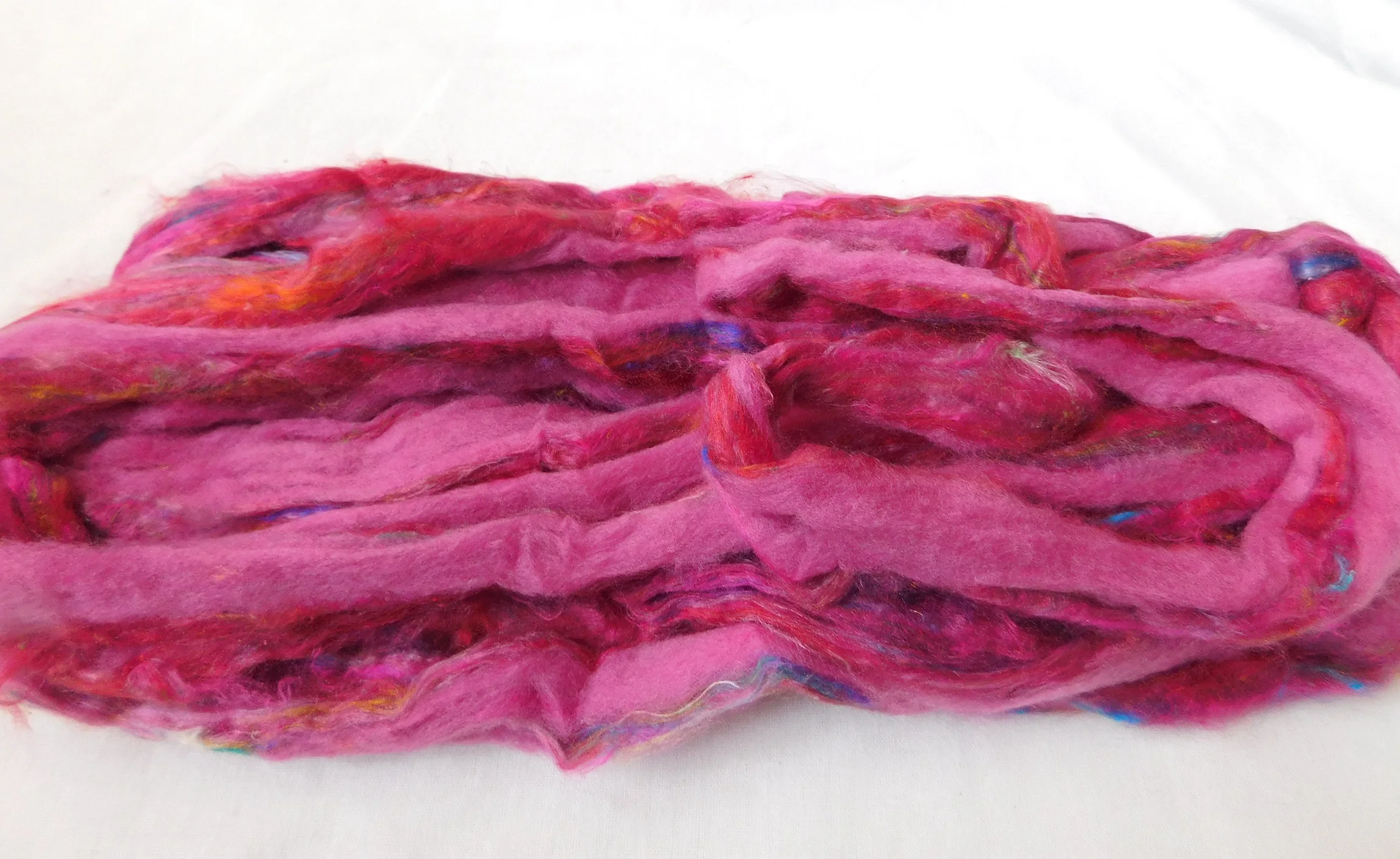 sari silk roving in two tone custom dyed colors suitable for yarn and fiber stores made from recycled silk fiber