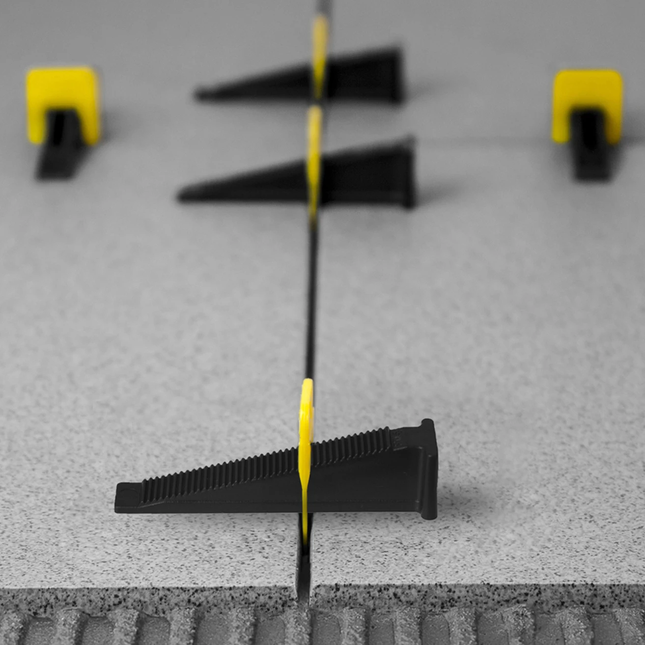 Plastic tile leveling wedges improves the quality of the cladding allowing you to make the surface completely flat