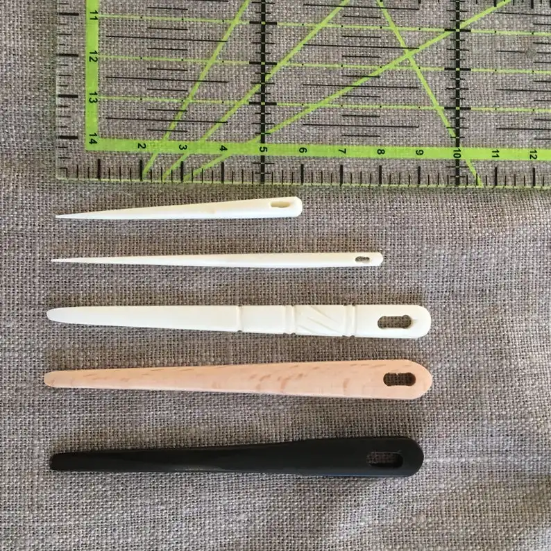 natural and historical bone needles with engraving design from viking age for using in knitting