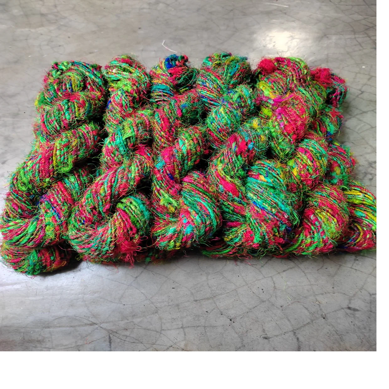 custom made sari silk yarn in an assortment of multi colors made from recycled sari waste suitable for yarn and fiber stores