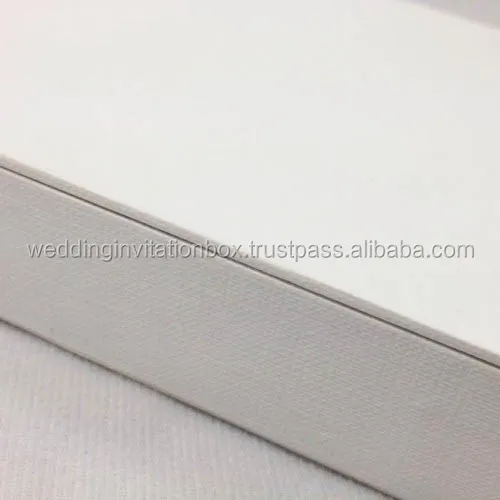 White hand-crafted paper wedding invitation box with thick cardboard walls