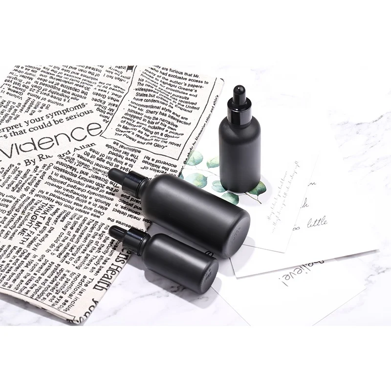 High end custom frosted matte black cosmetic glass bottle for lotion serum essential oil