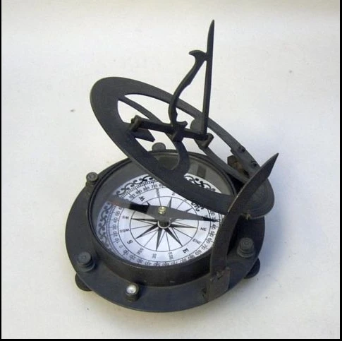 brass compass on wooden box