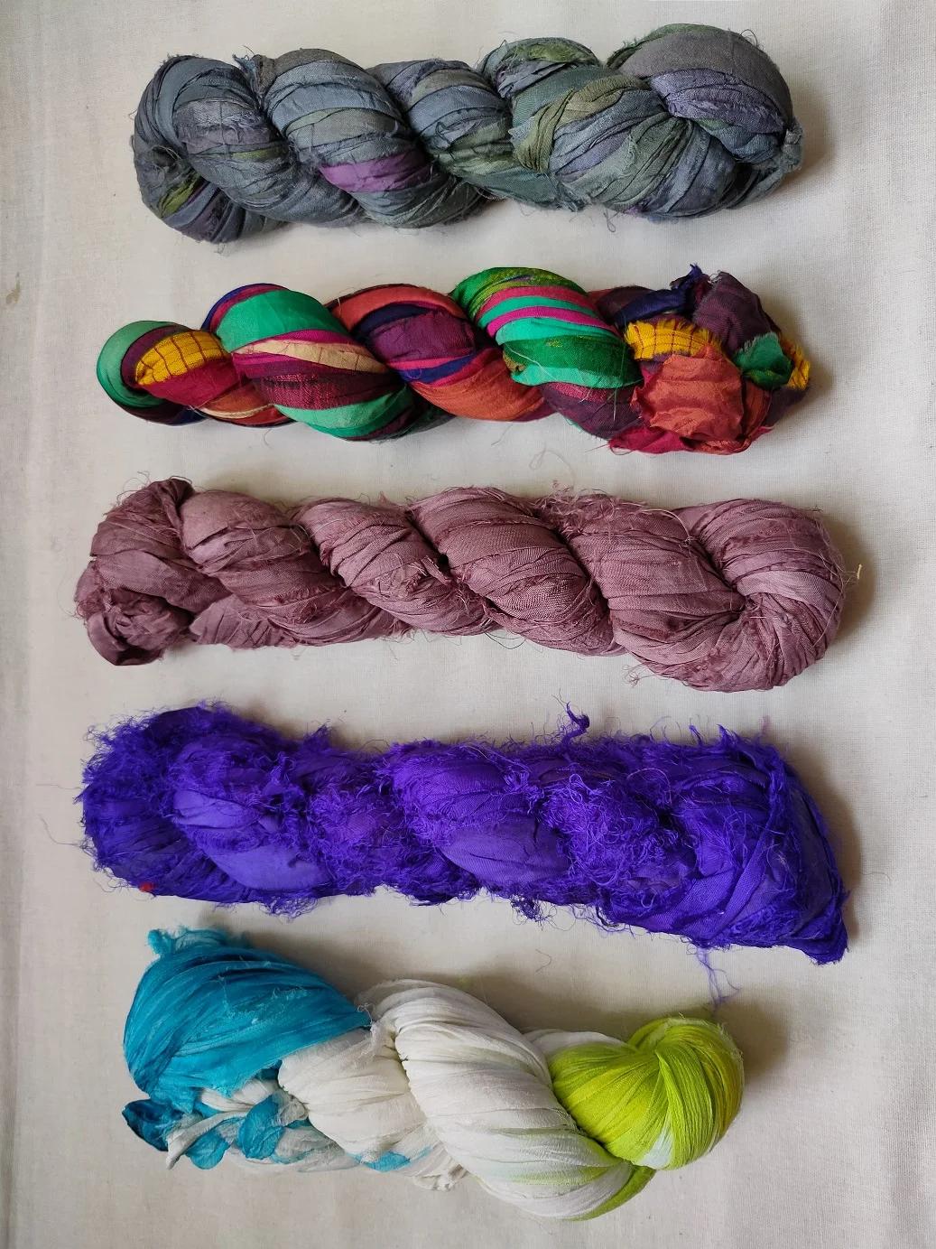 sari silk ribbon made from recycled silk sari available in 100 gram skeins suitable for yarn and fibre stores and for jewellery