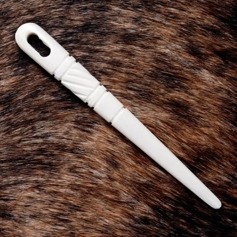 natural and historical bone needles with engraving design from viking age for using in knitting