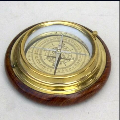 brass compass on wooden box